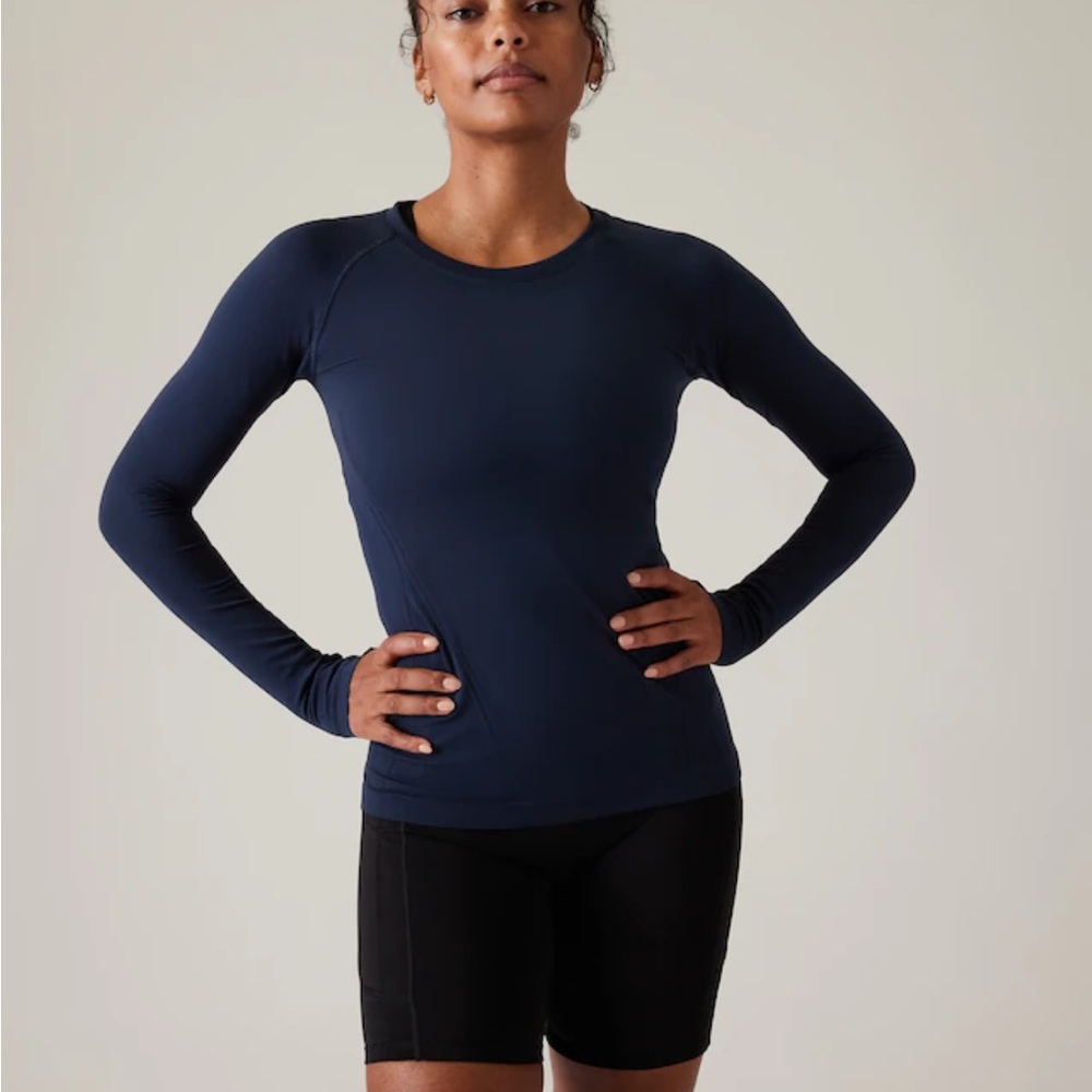 Athleta Long sleeve momentum top. Only worn once. Color is dark green.